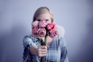 woman holding pink roses be more assertive