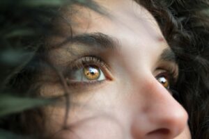 Abundance closeup photo of woman's face eyes crush fear